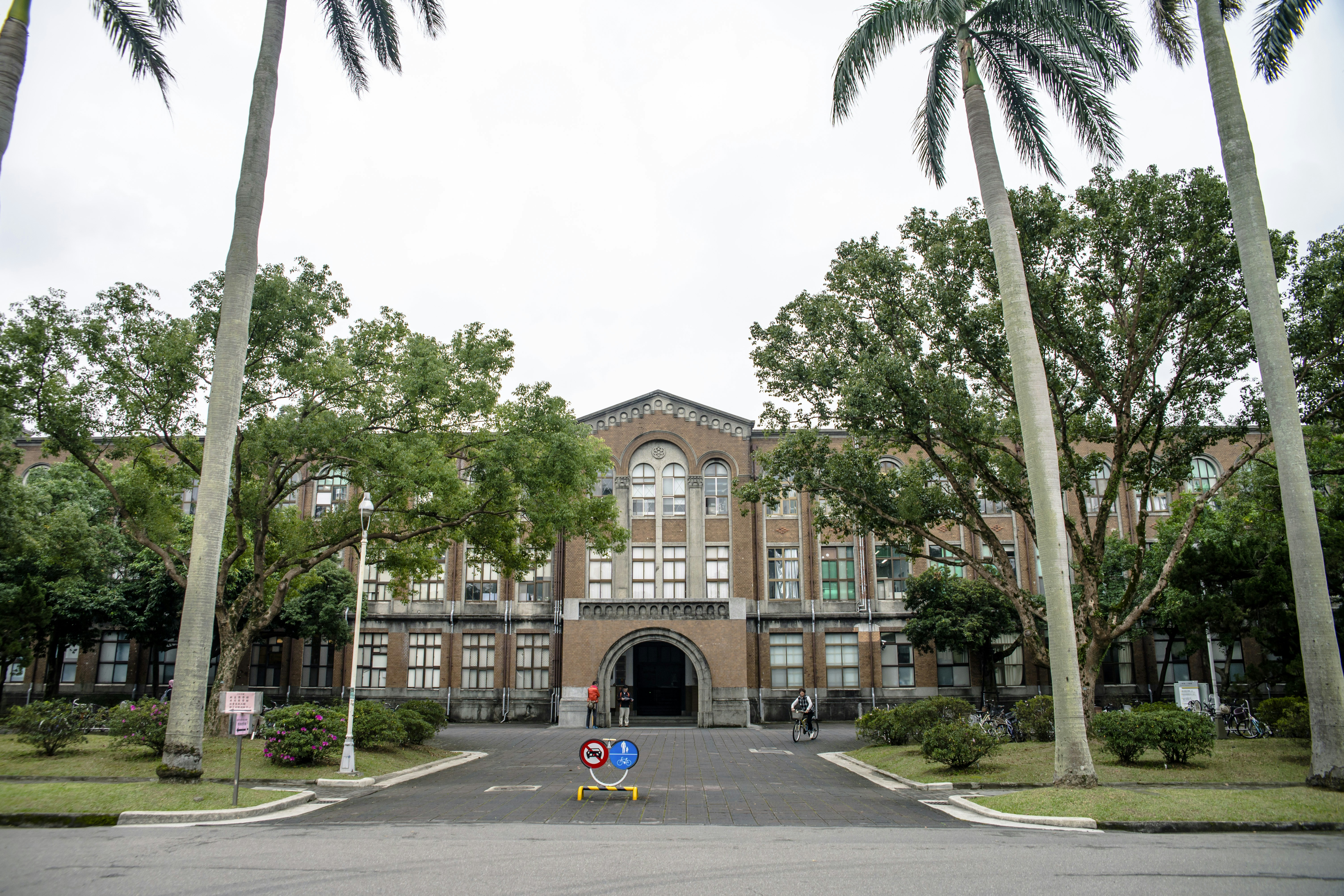 a large building with palm trees in front of it