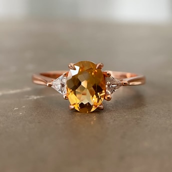 a yellow diamond ring with three diamonds on it