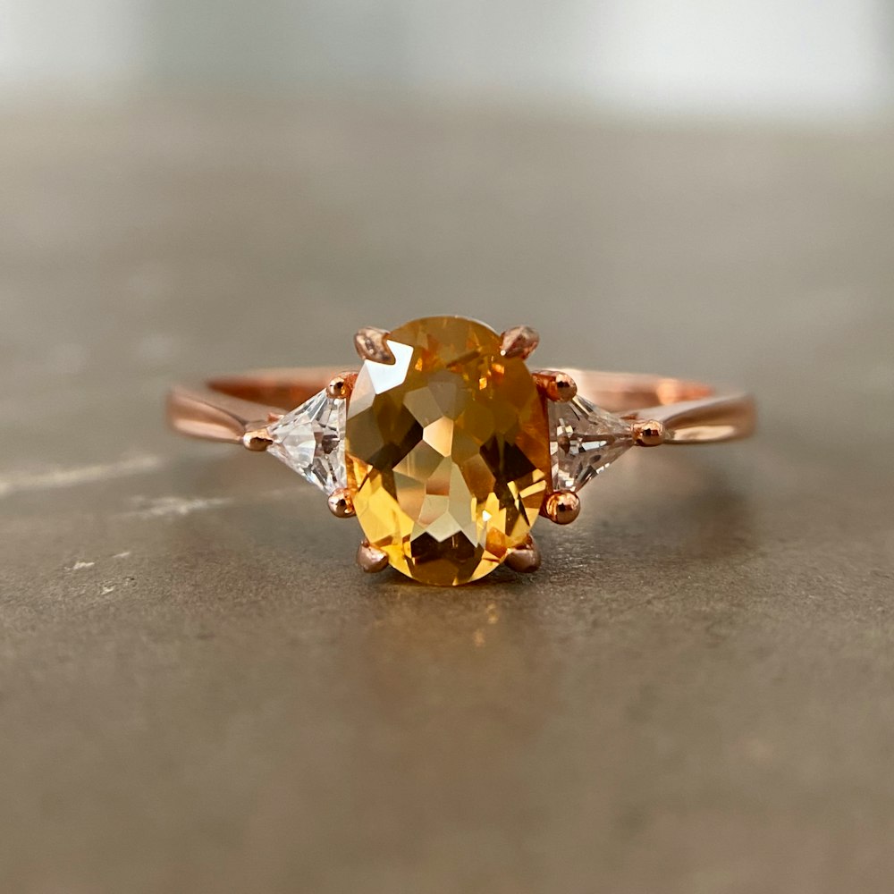 a yellow diamond ring with three diamonds on it