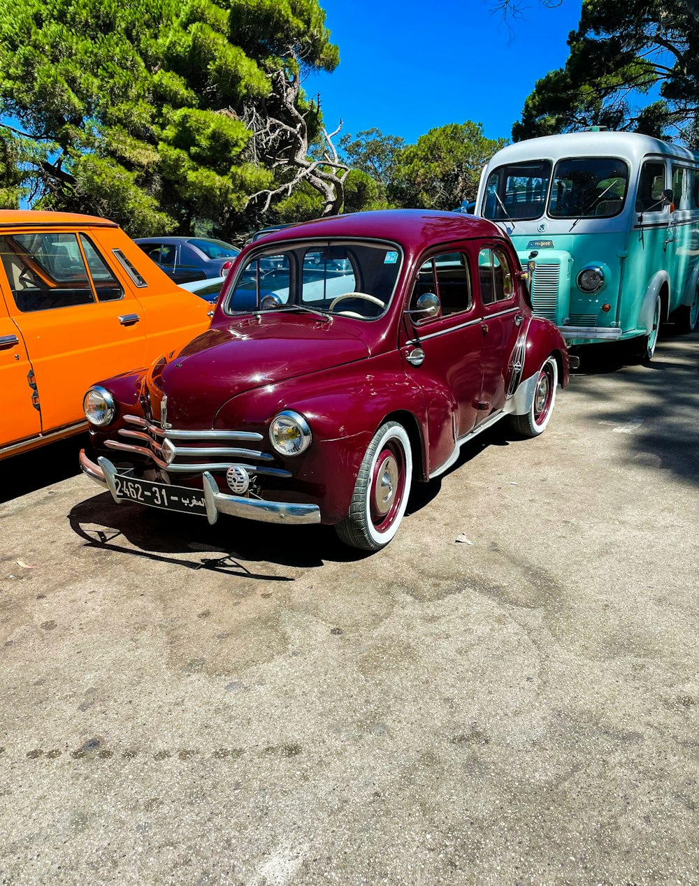 a row of old cars parked next to each other
