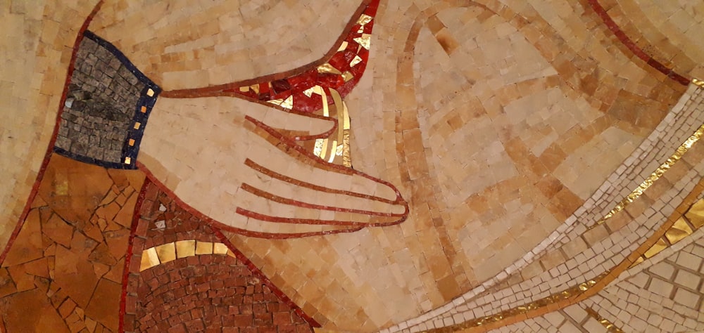 a close up of a mosaic of a woman's hand