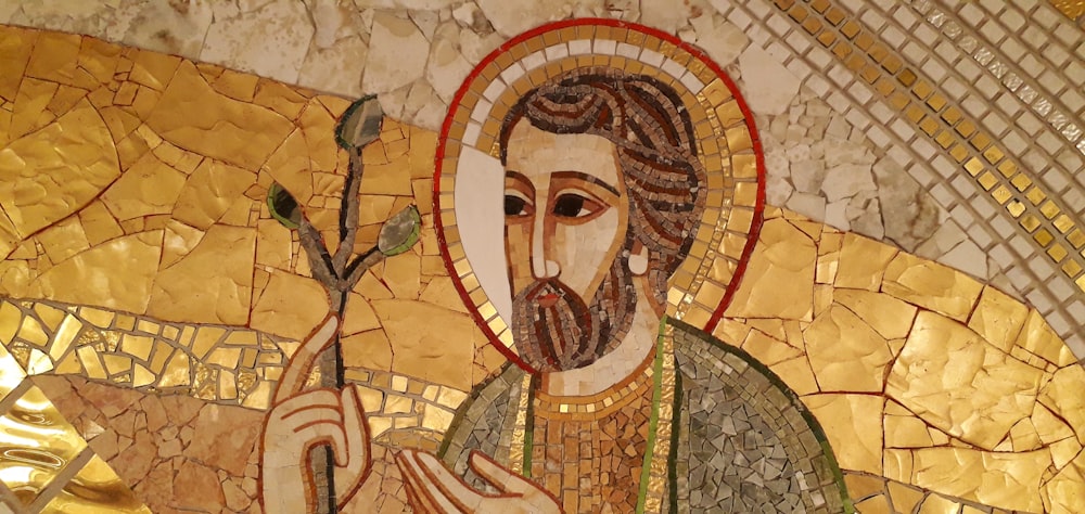 a mosaic of a man holding a flower