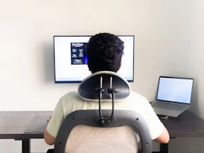a man sitting in front of a computer monitor