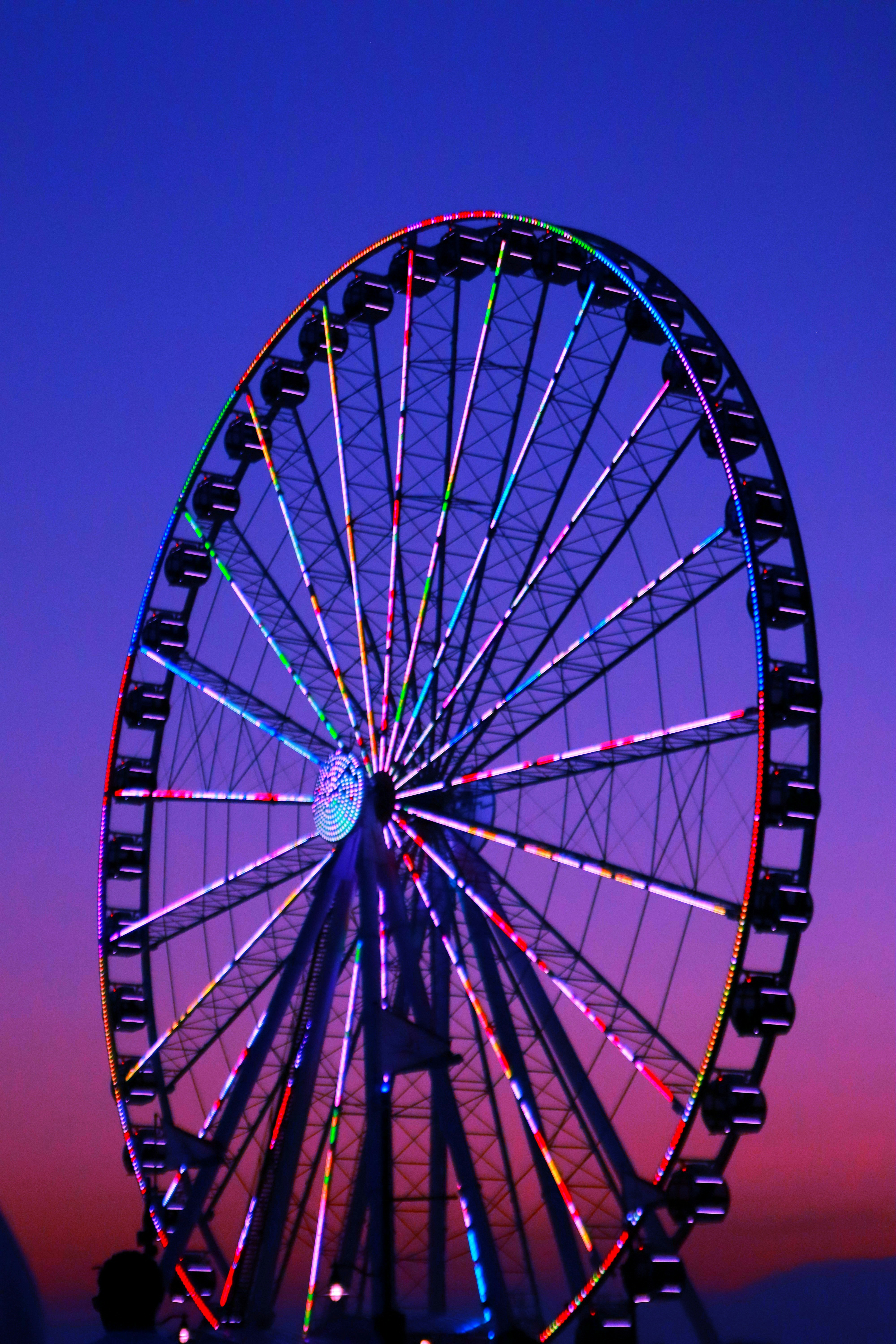 A ferris wheel is lit up at night photo Free Baltimore Image on Unsplash