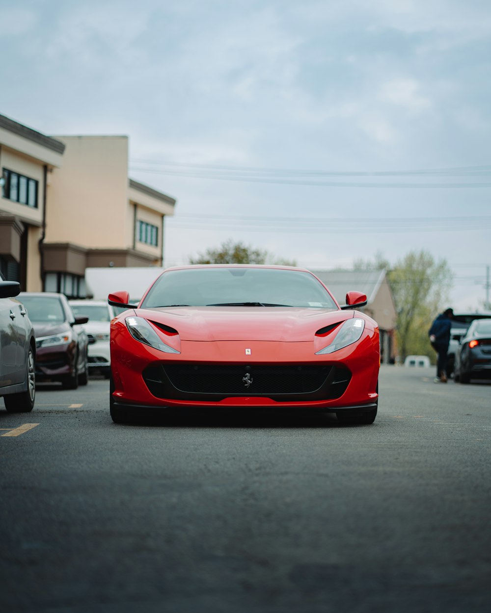 a red sports car parked in a parking lot