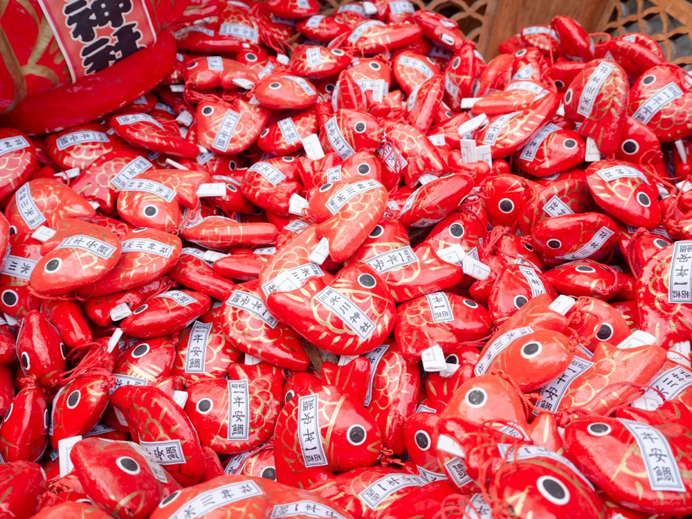 a pile of red heart shaped candies sitting on top of a table