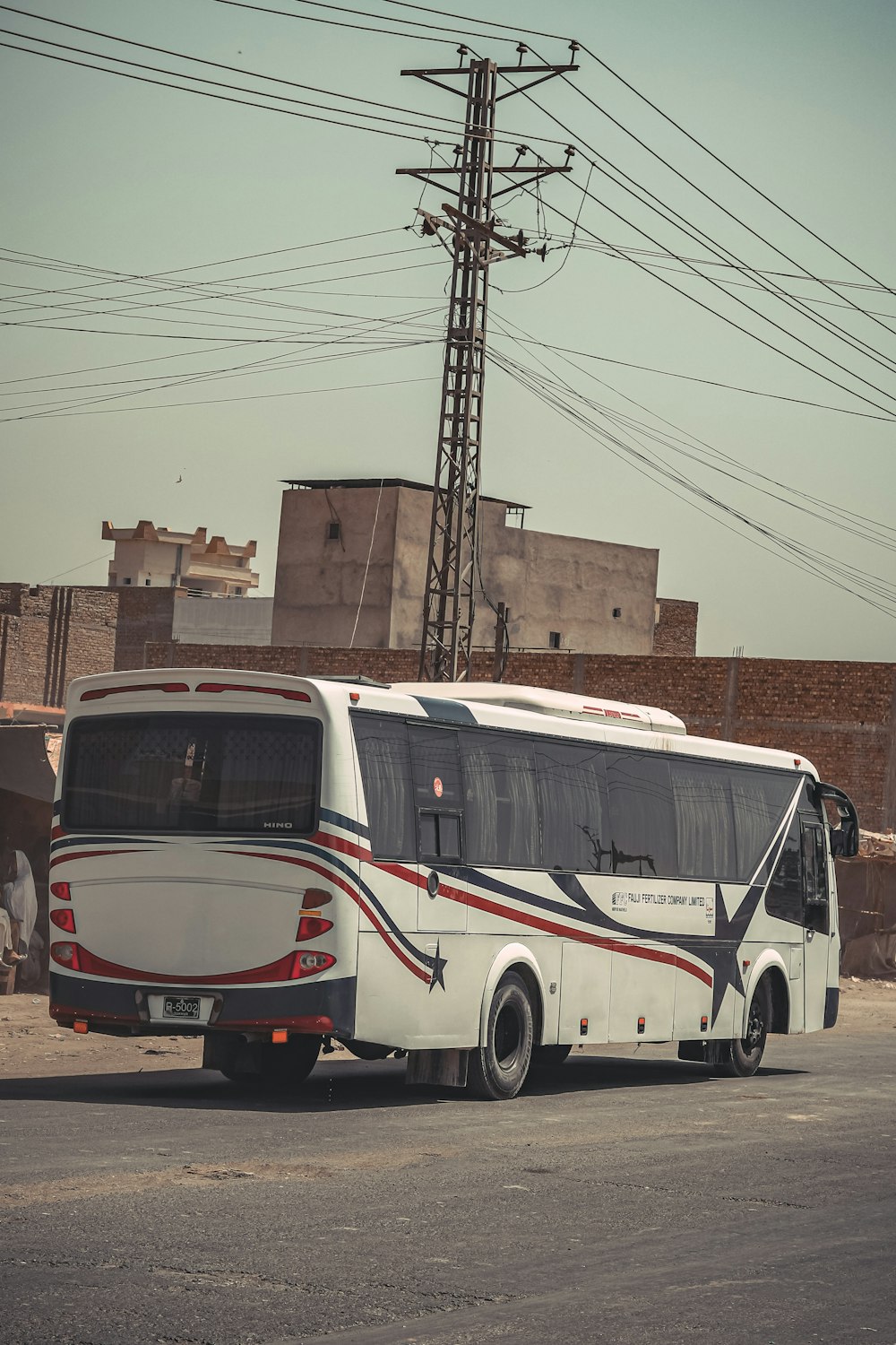 a white bus parked on the side of the road