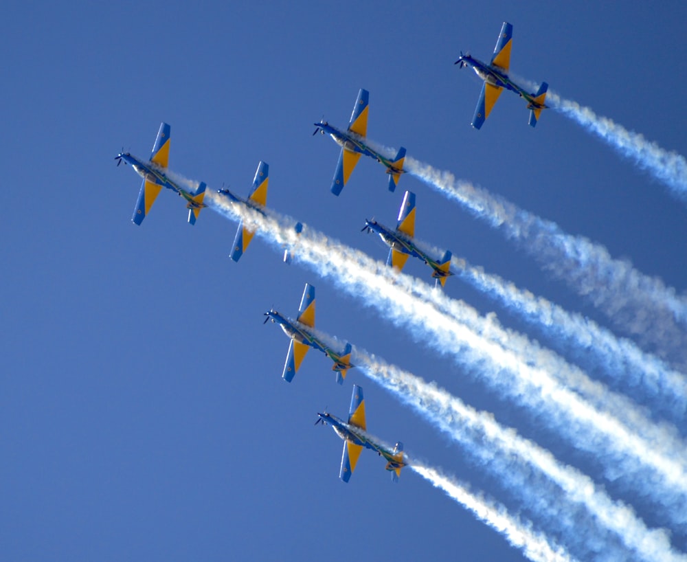 a group of airplanes flying through a blue sky