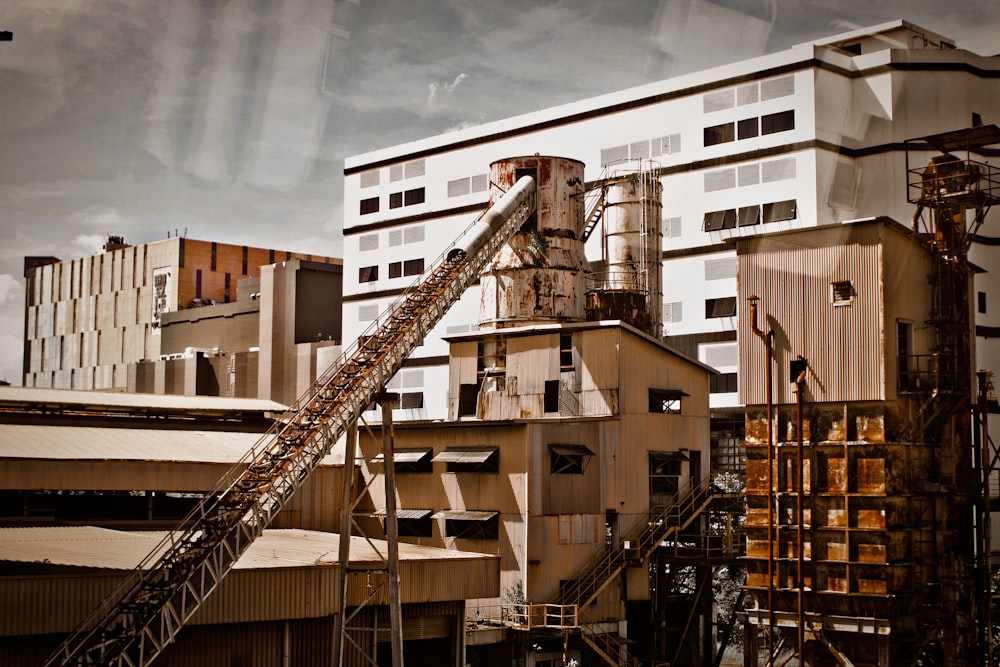 a factory building with a conveyor belt in front of it