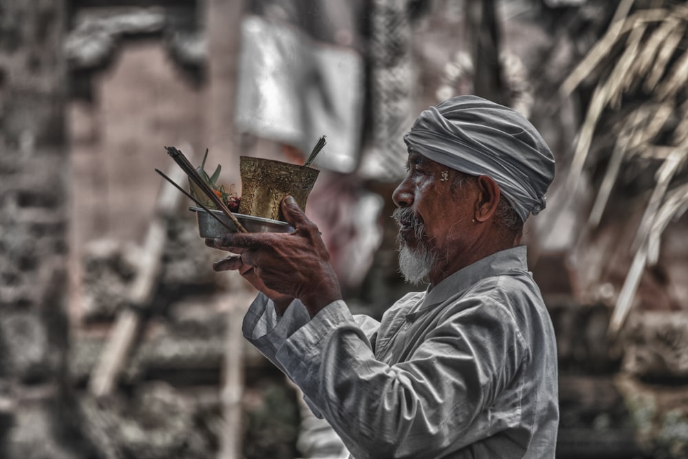 a man in a turban is holding a book