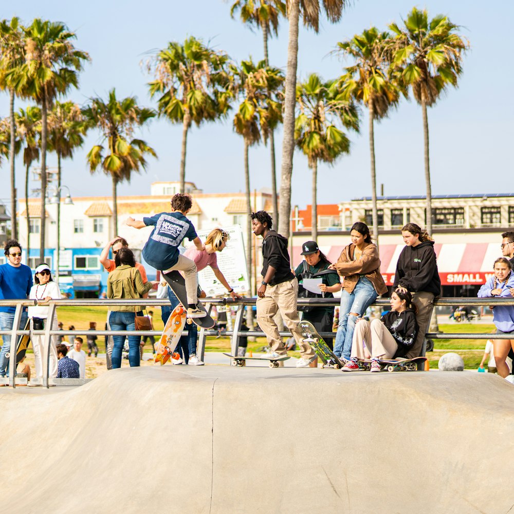 a group of people watching a skateboarder do a trick