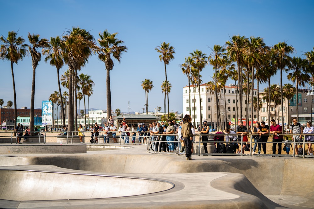 a group of people standing around a skate park