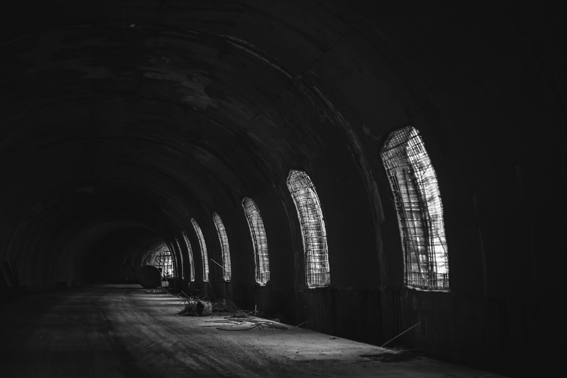 a black and white photo of a dark tunnel