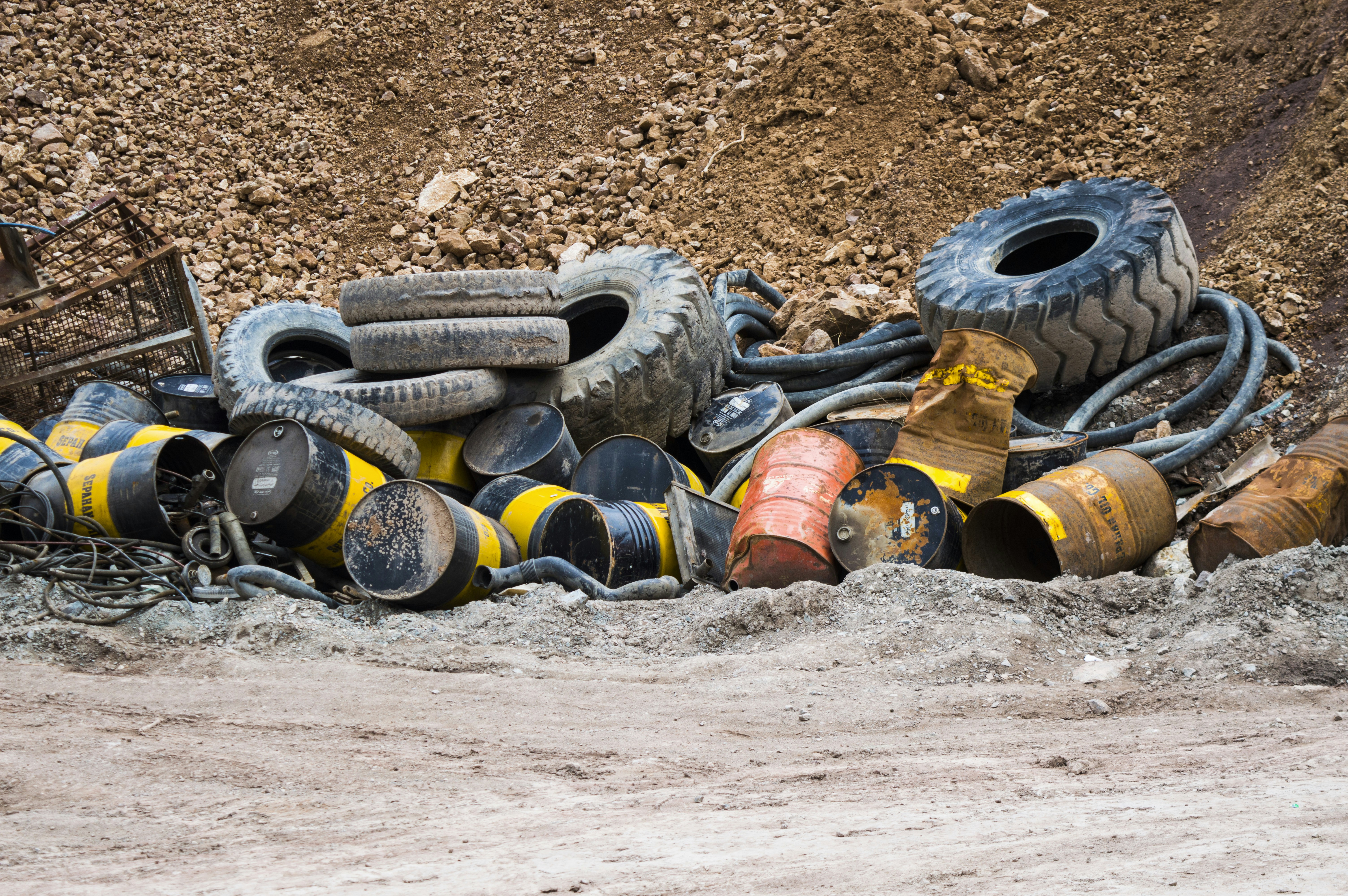 a pile of old tires sitting in the mud