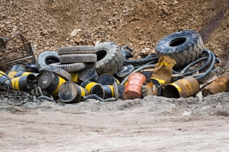 a pile of old tires sitting in the mud