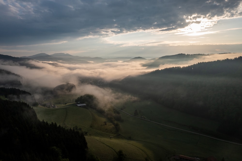 a view of a foggy valley in the mountains