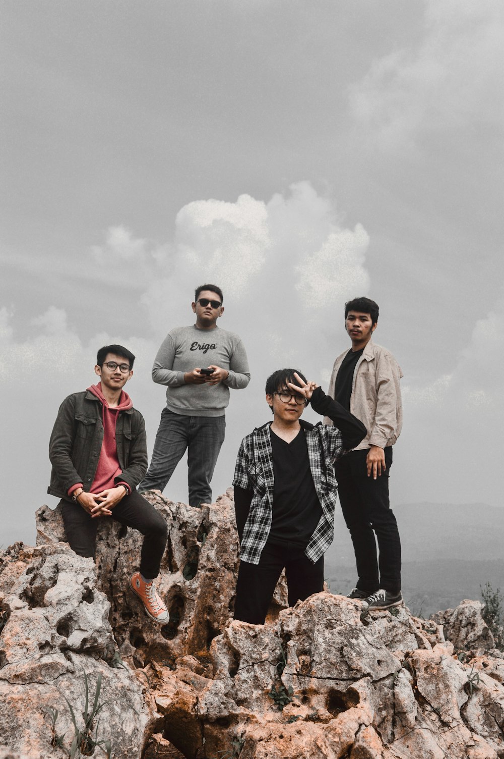 a group of men standing on top of a mountain