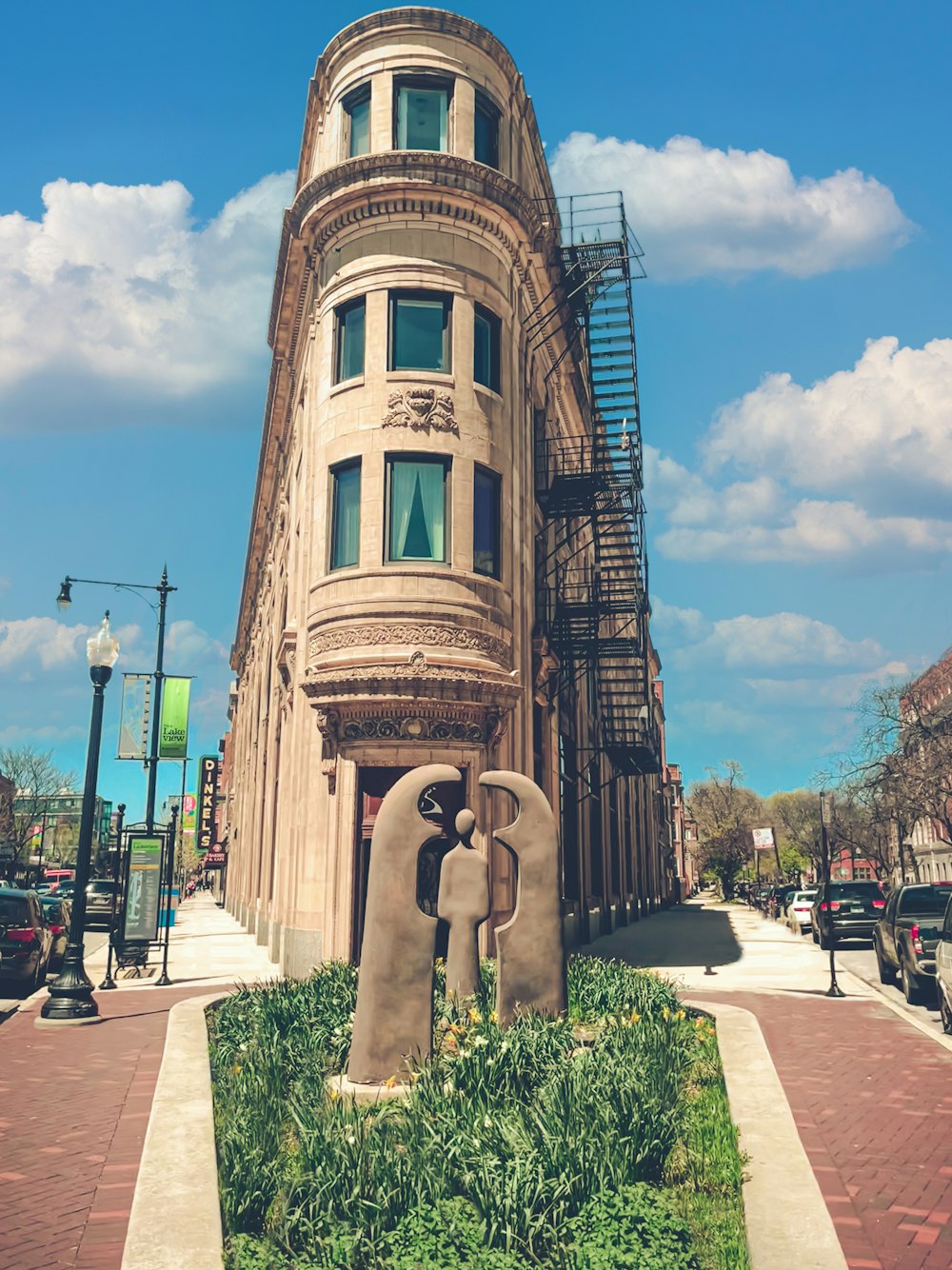 a tall building with a sculpture of two people in front of it