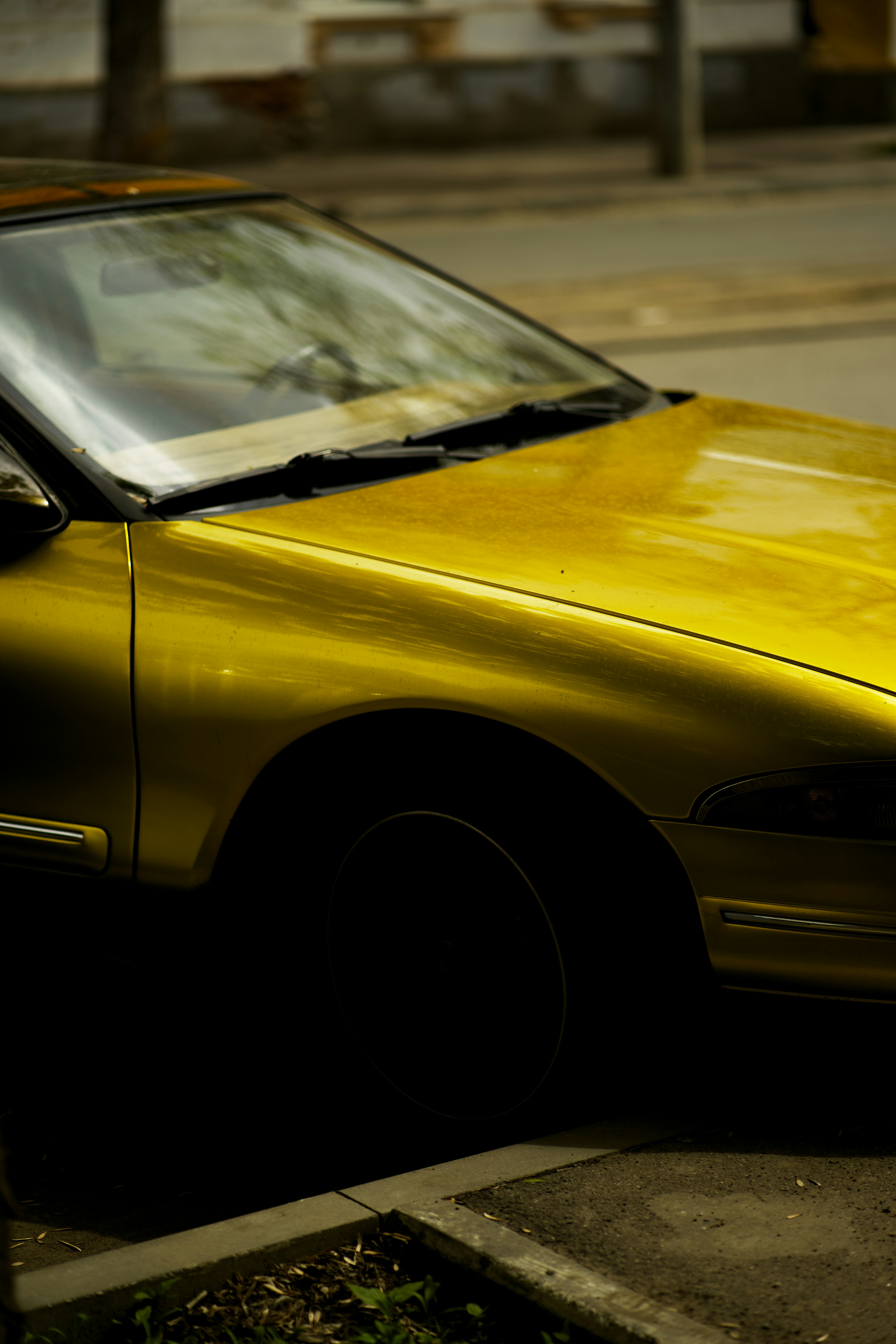 A yellow car parked on the side of the road photo – Free Street ...