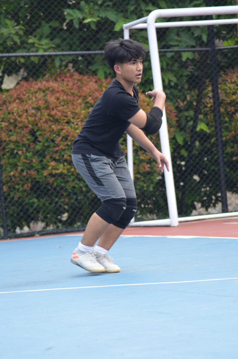 a young boy is playing tennis on a court