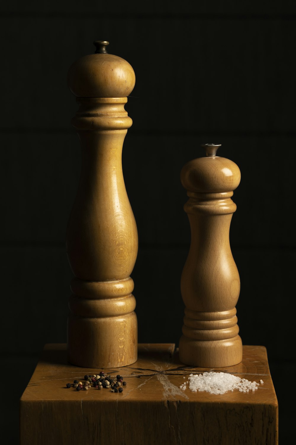 a wooden pepper mill and salt mill on a table