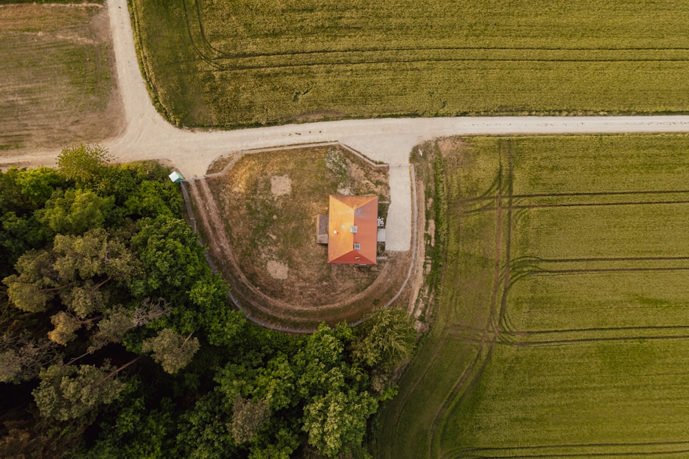an aerial view of a house in the middle of a field