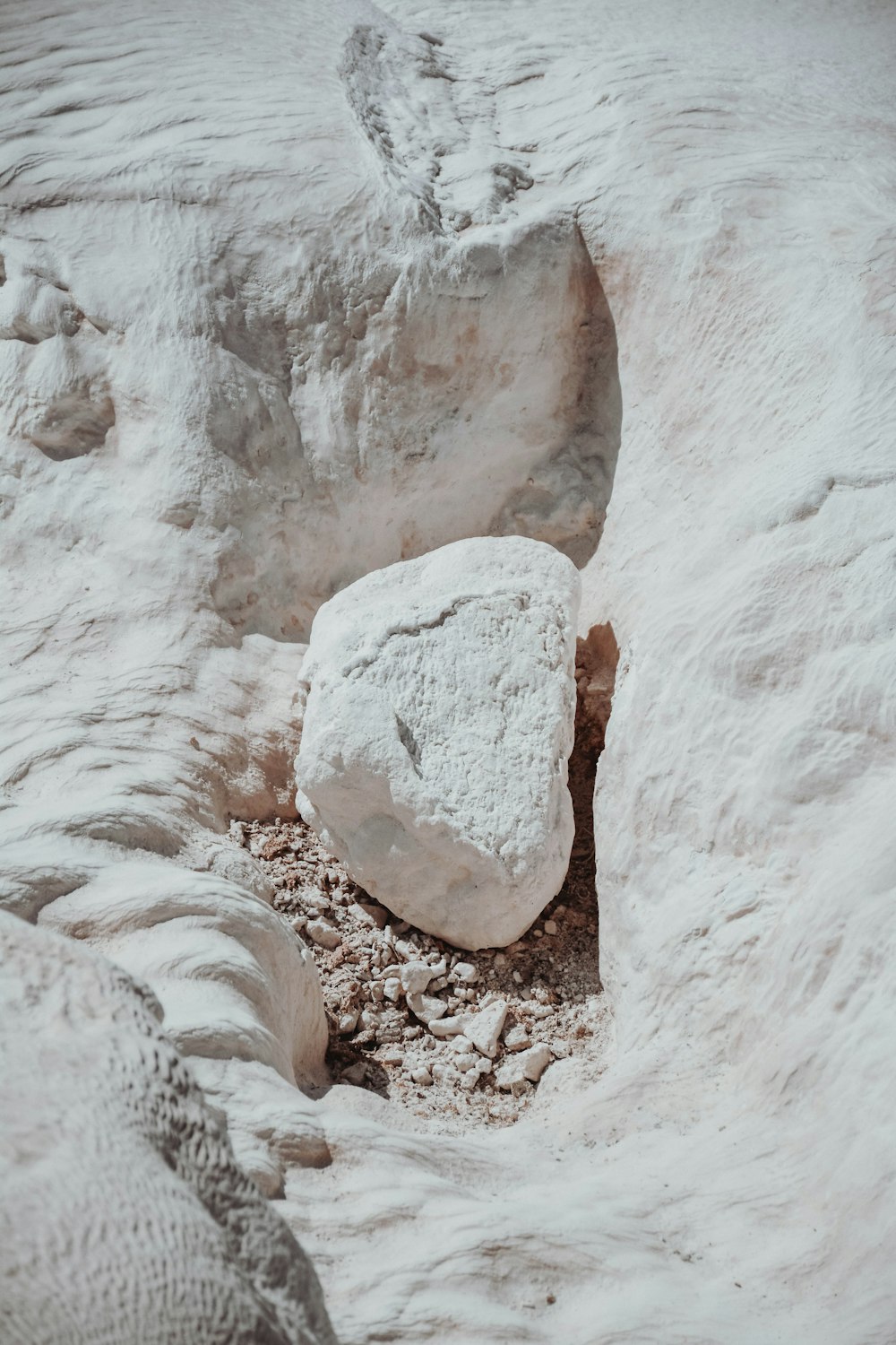 a large rock in the middle of a desert