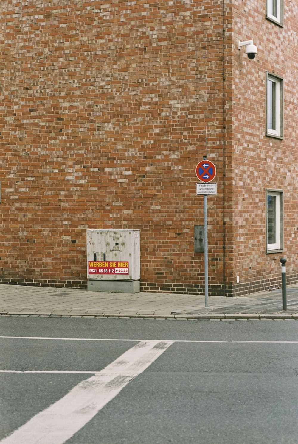 a brick building with a street sign in front of it