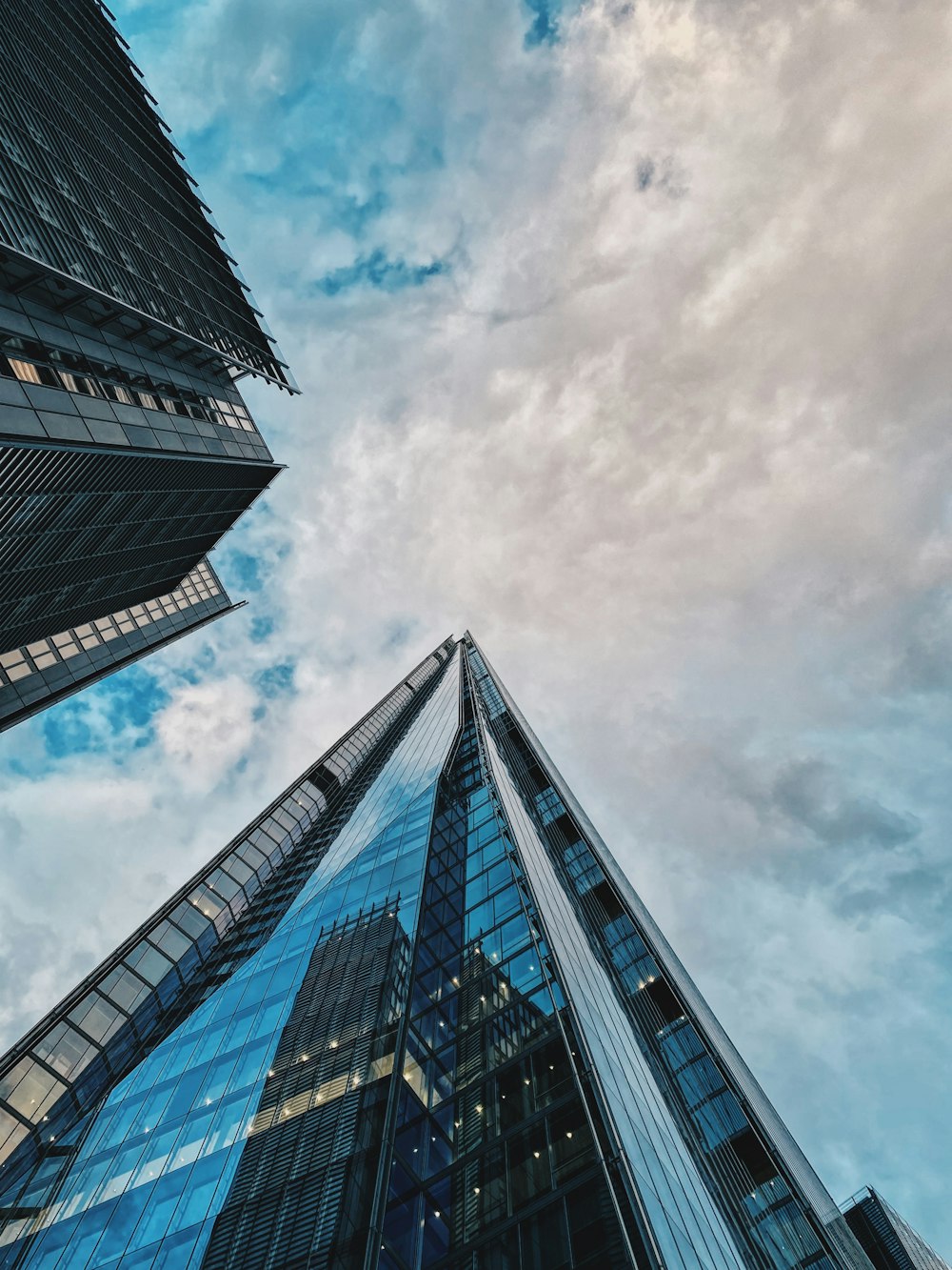 looking up at the top of two skyscrapers