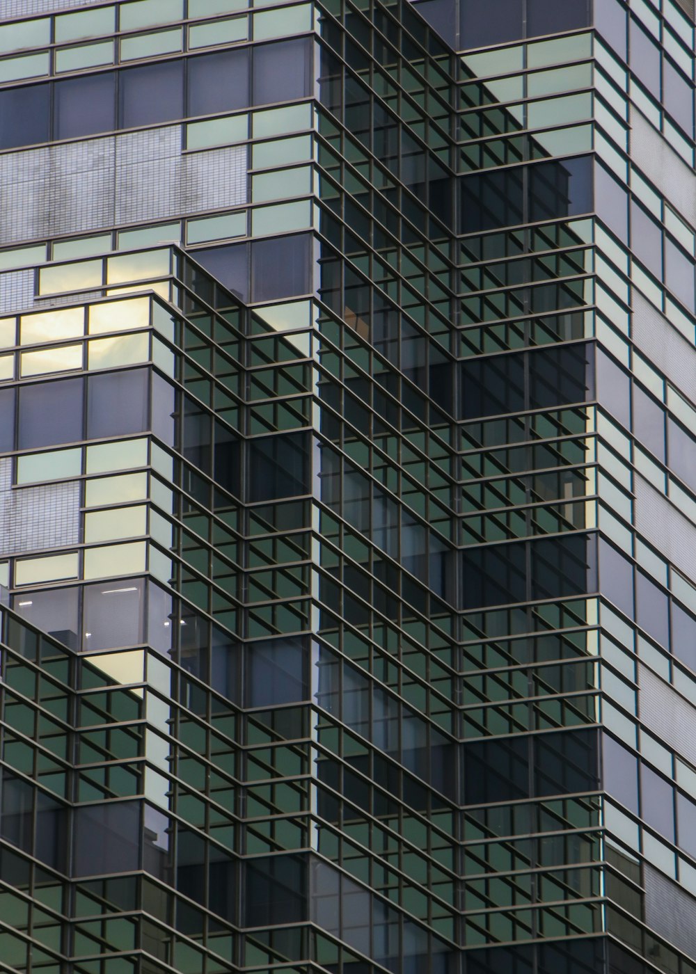 a plane flying in front of a very tall building