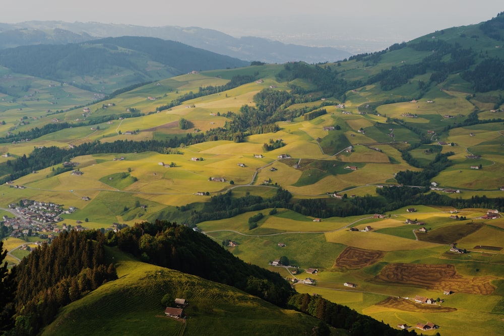 a view of a valley with a village in the distance