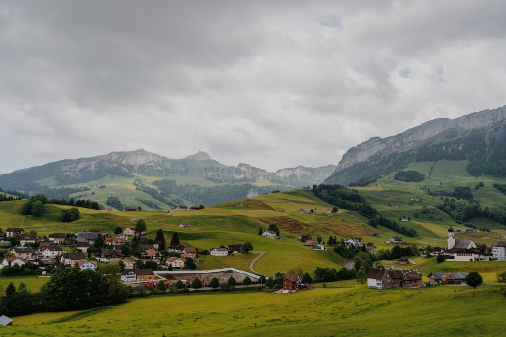 a small village in the middle of a green valley