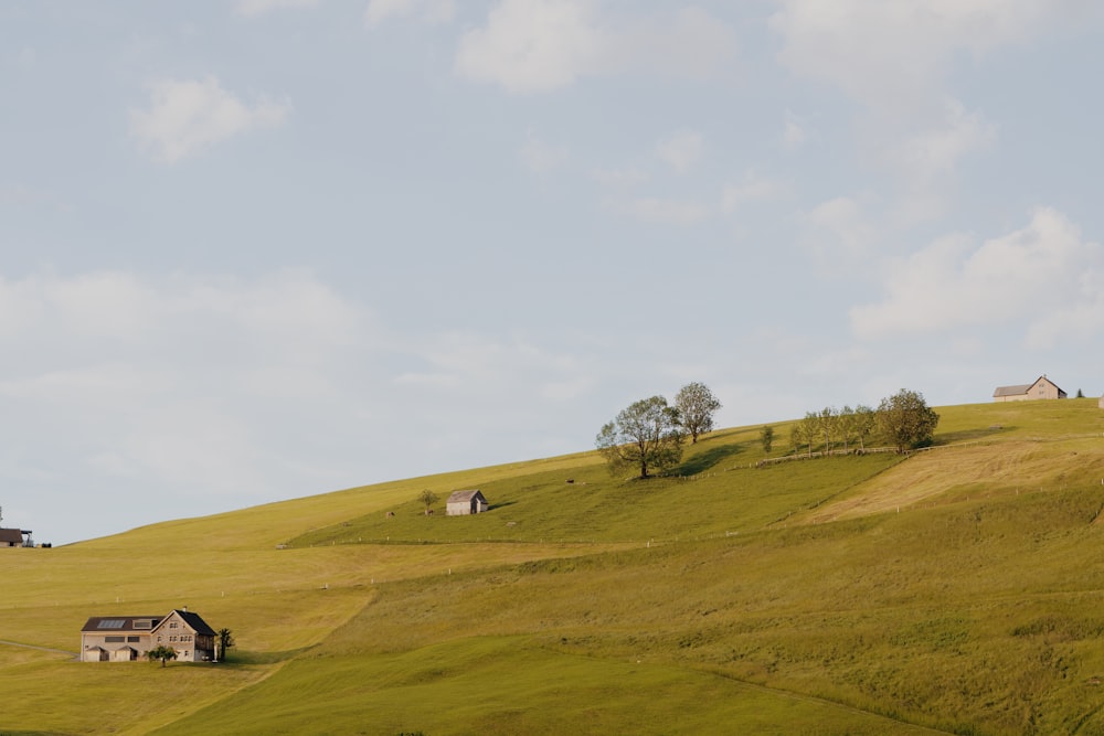 a grassy hill with a house on top of it