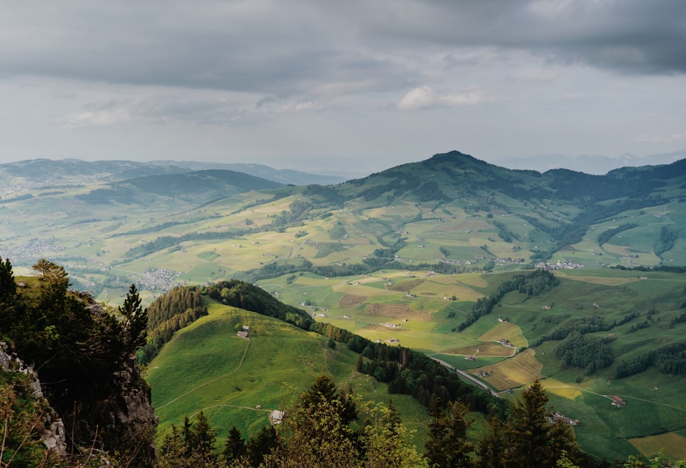 a view of a valley with mountains in the background