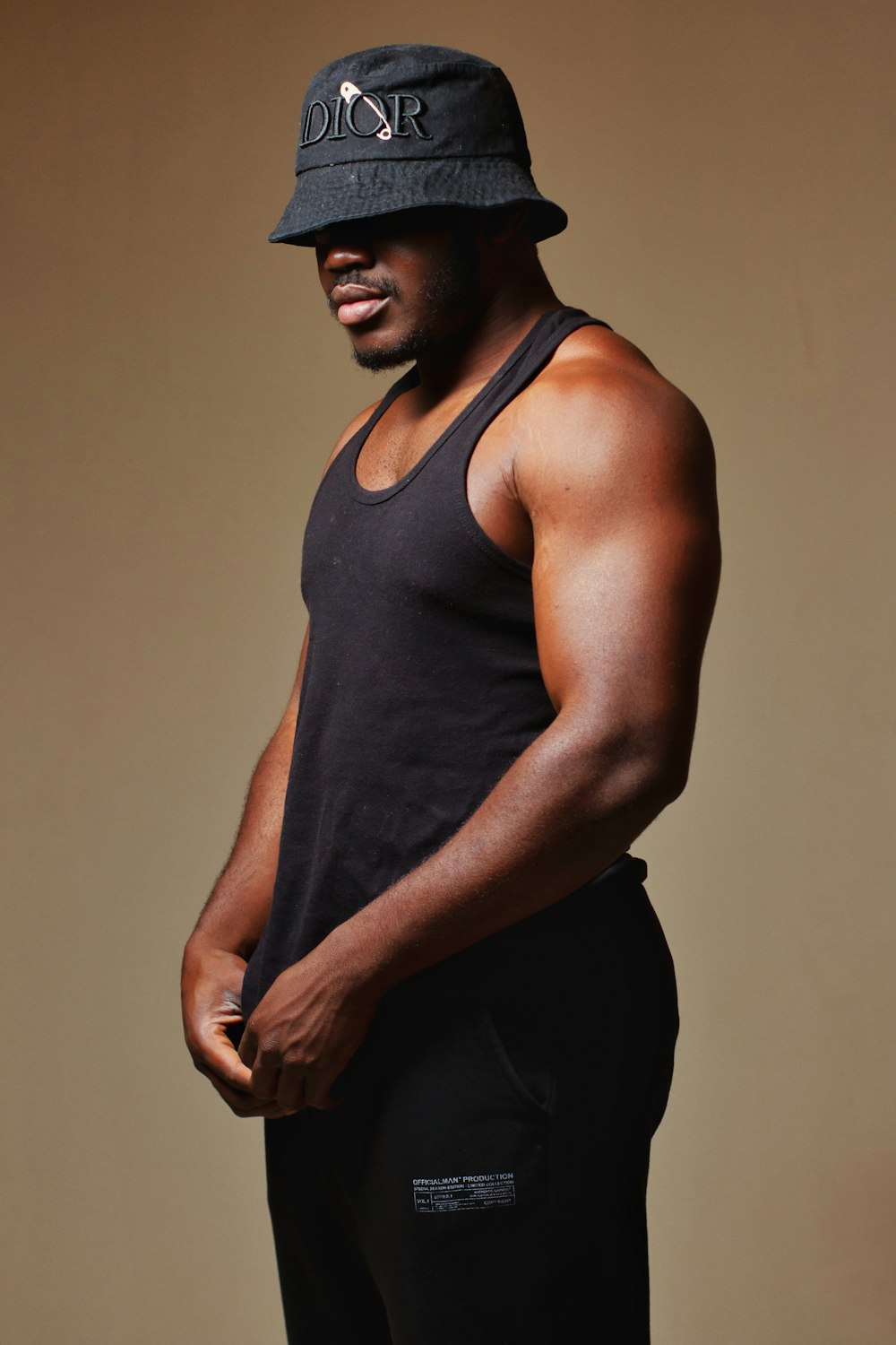 a man in a black tank top and a black hat