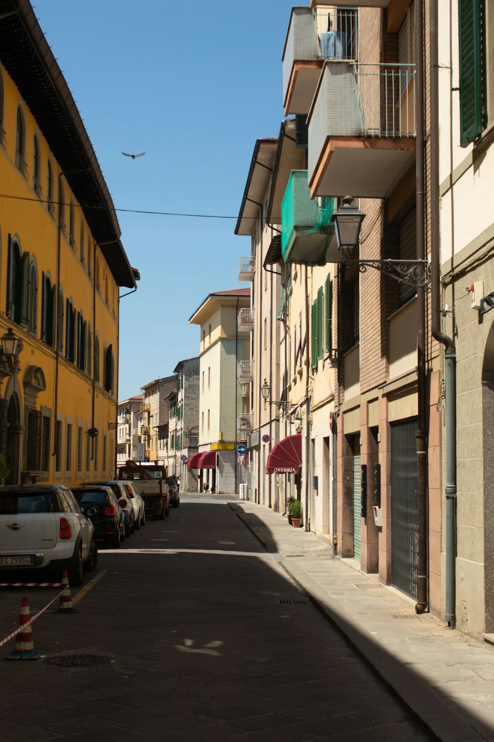 a city street lined with tall buildings and parked cars