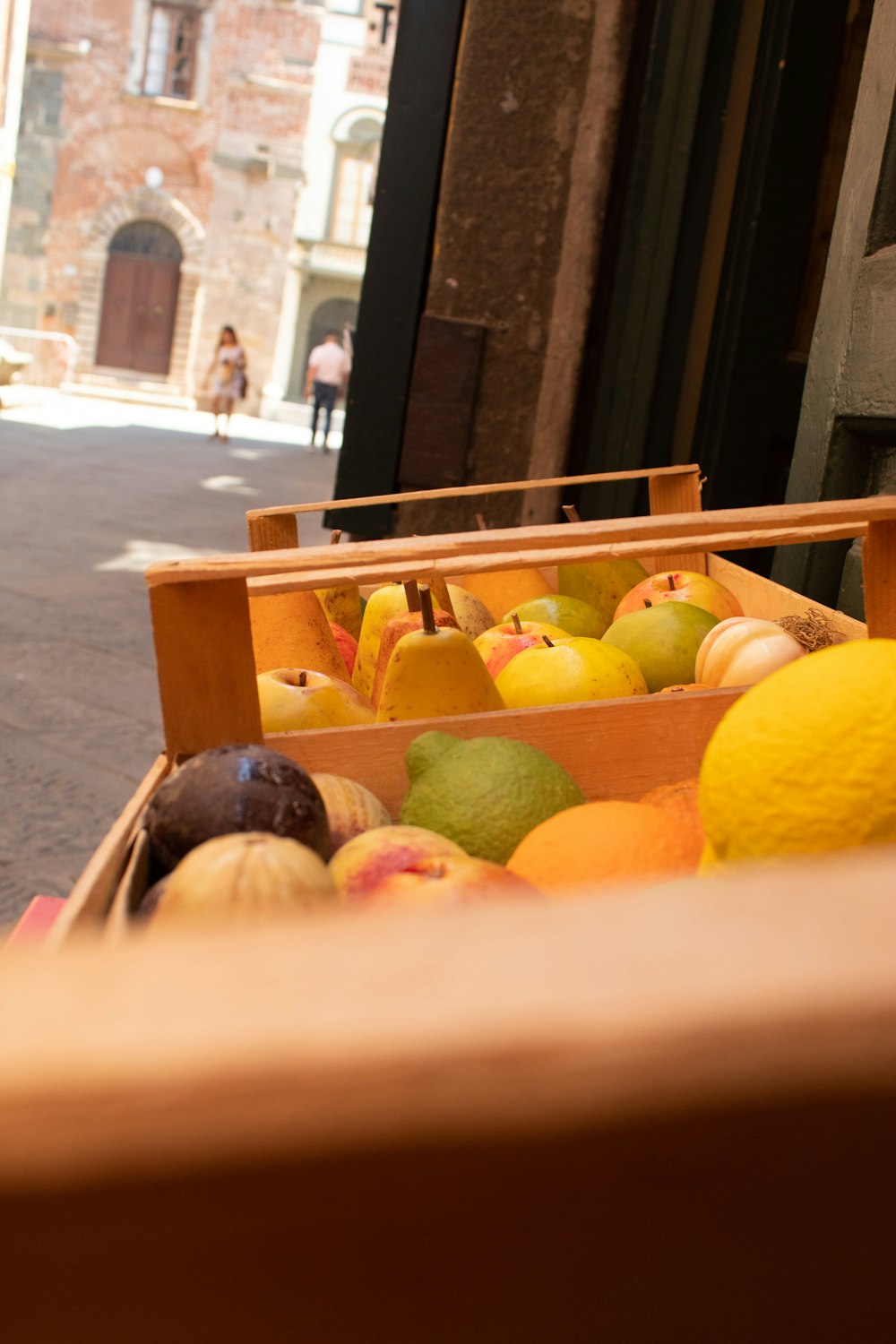 a wooden box filled with lots of different types of fruit