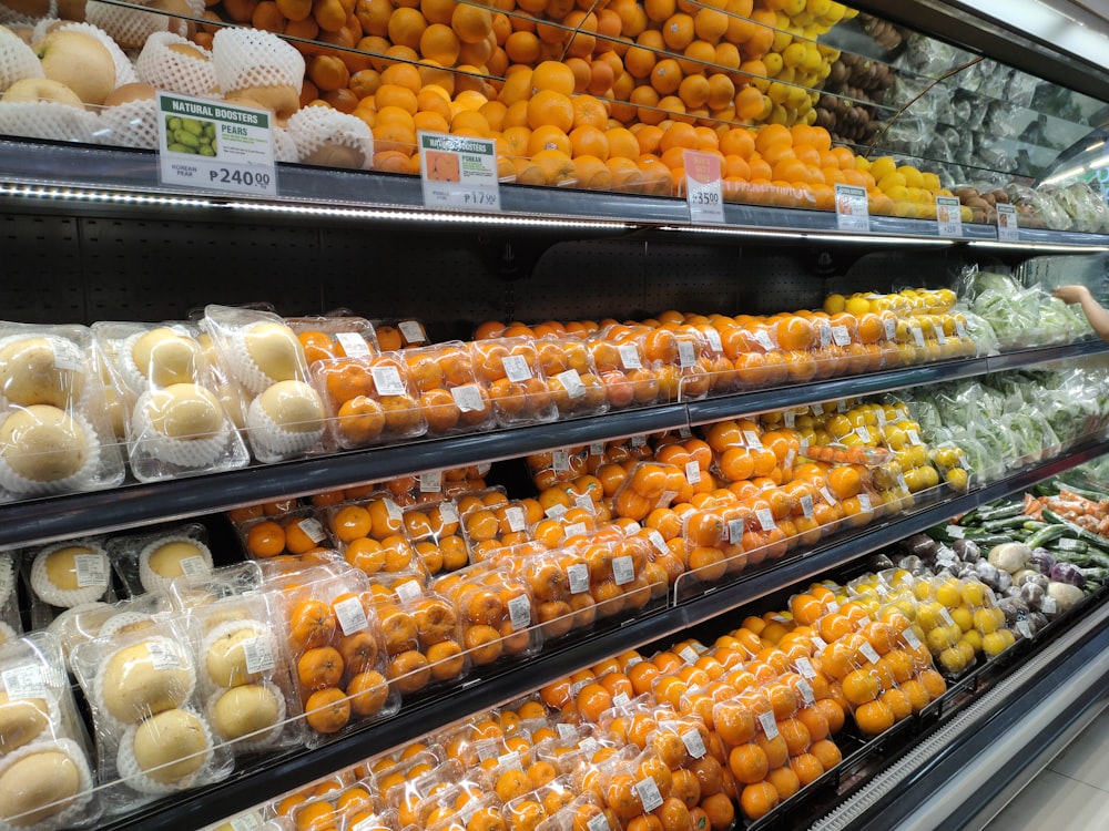 a display in a grocery store filled with lots of oranges