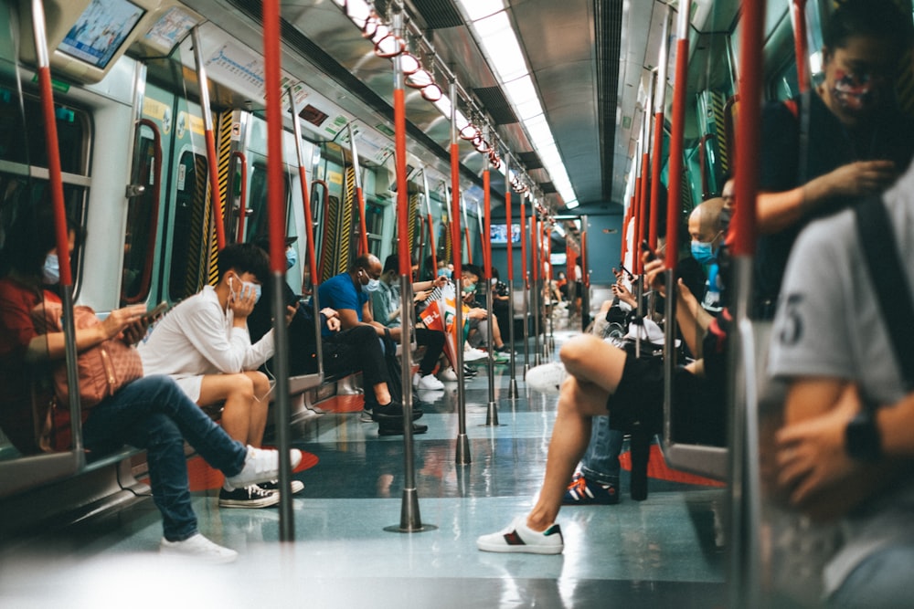 a group of people sitting on a subway train