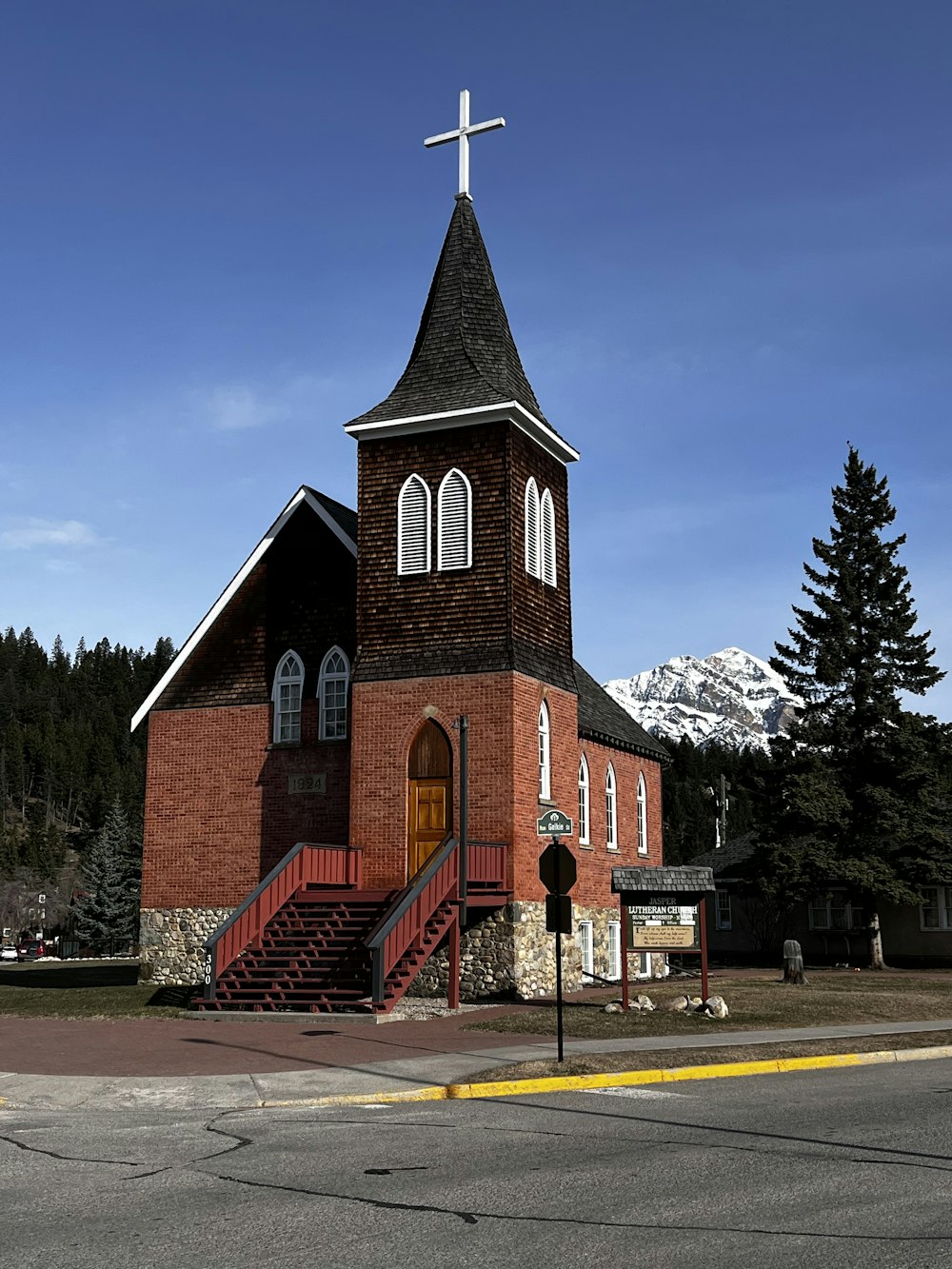 a church with a steeple and a cross on top