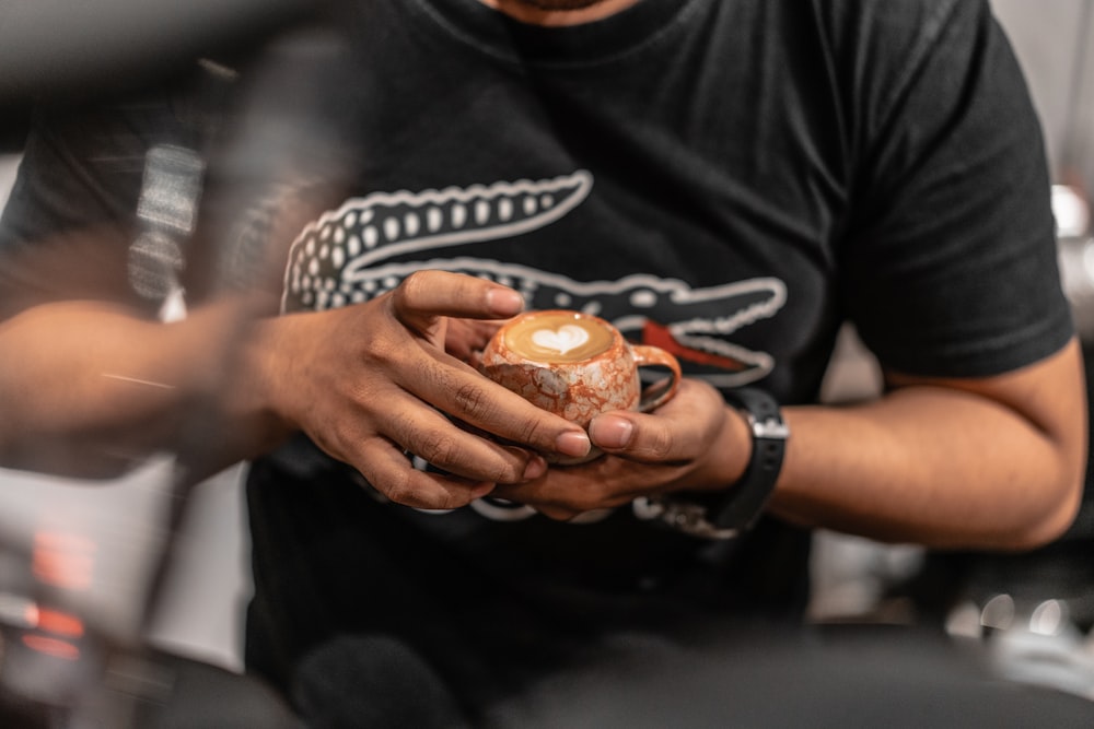 a man holding a piece of food in his hands