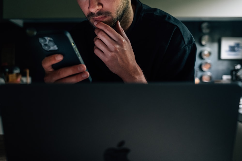 a man sitting in front of a laptop computer