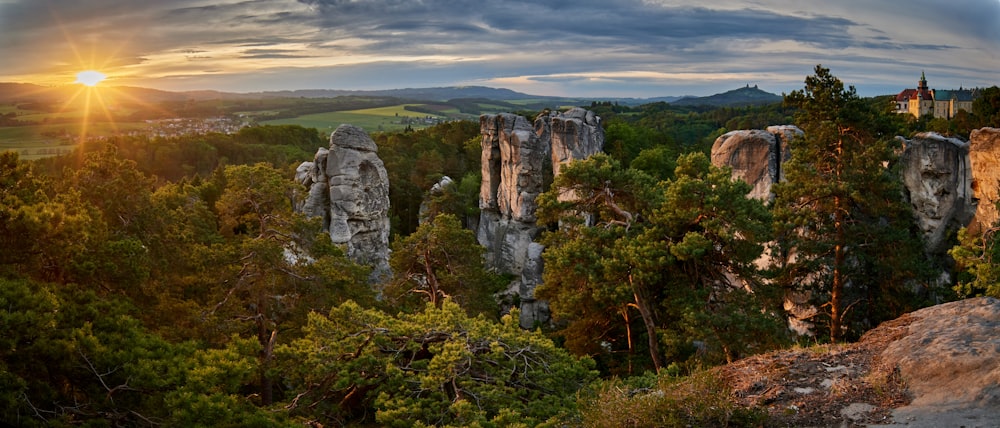 the sun is setting over the rocky landscape