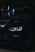 Close-up of a sleek car diffuser with a glossy black finish under sharp lighting.
