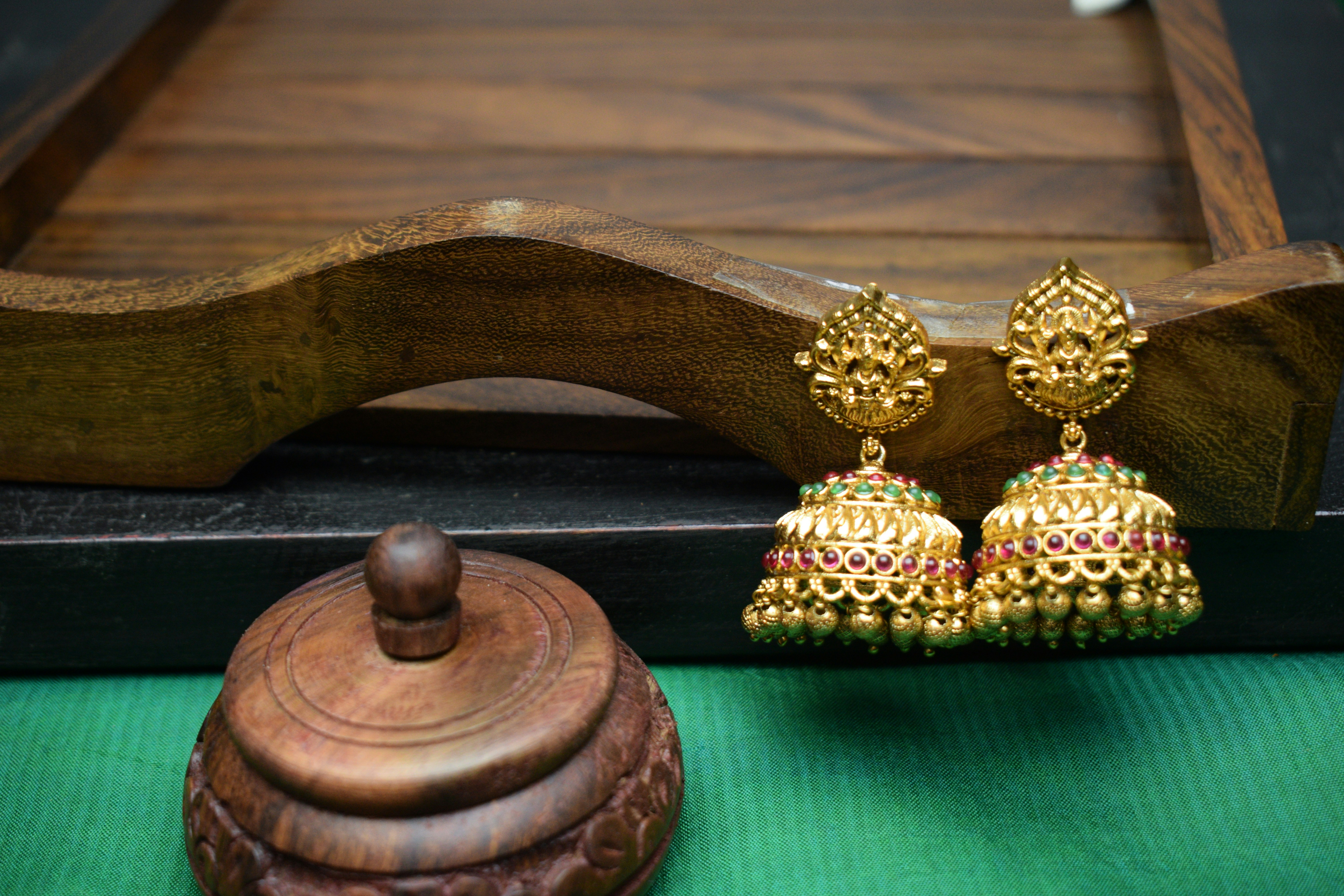 a close up of a pair of earrings on a table