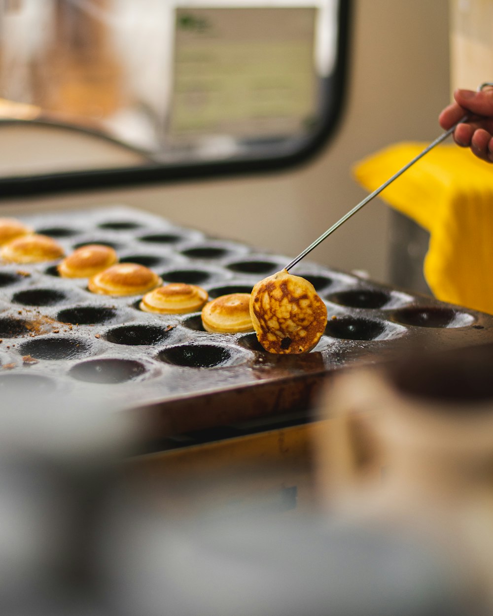 a person using a pair of tongs to cut a donut