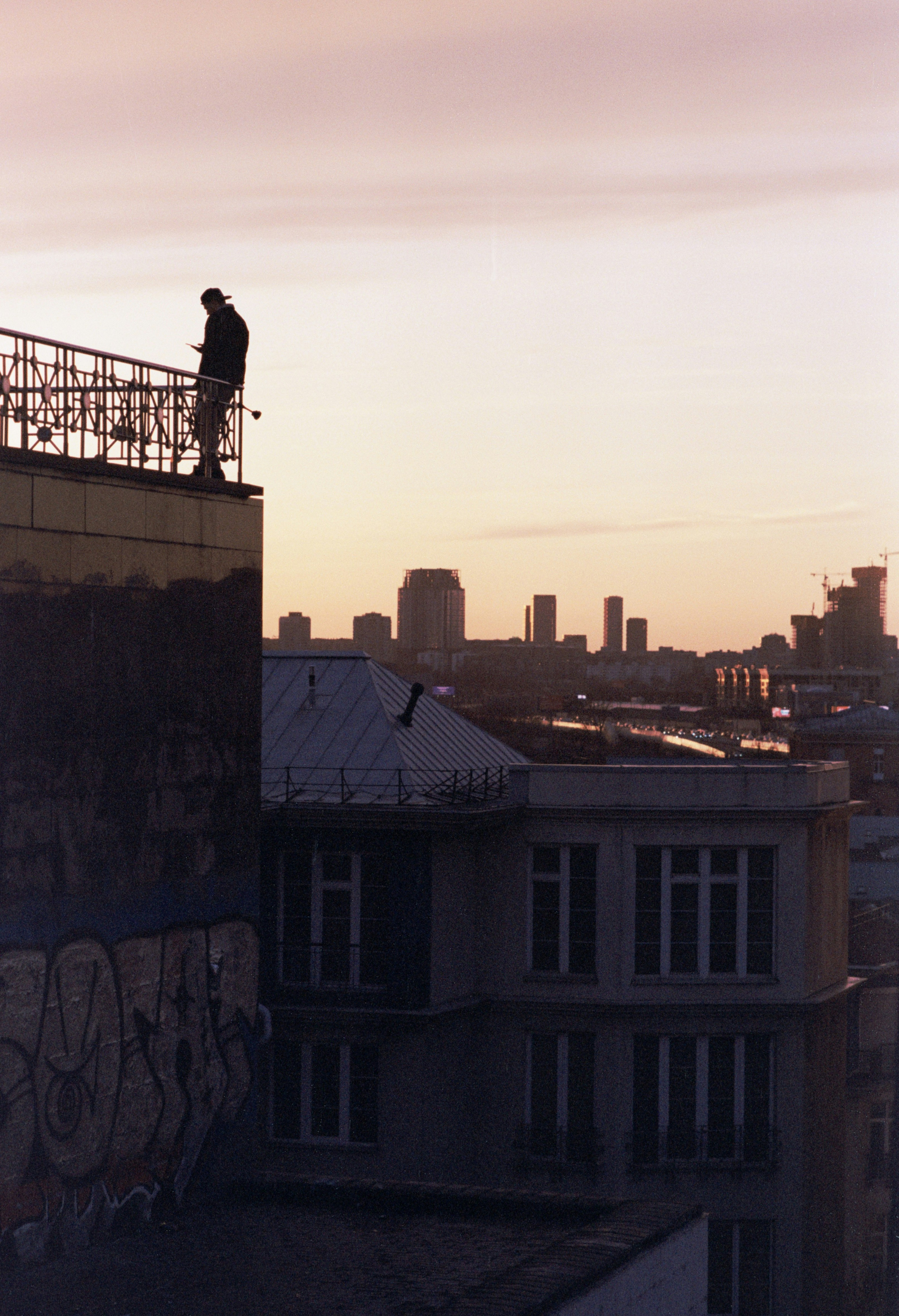 a man standing on top of a tall building
