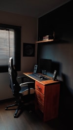 Dedicated desk setup with ergonomic chair and personal storage.