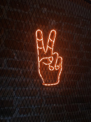 a neon sign with a peace sign in the middle of it