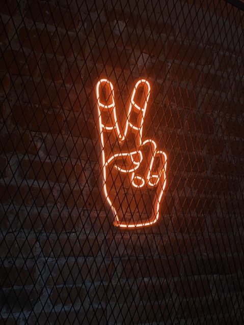 a neon sign with a peace sign in the middle of it